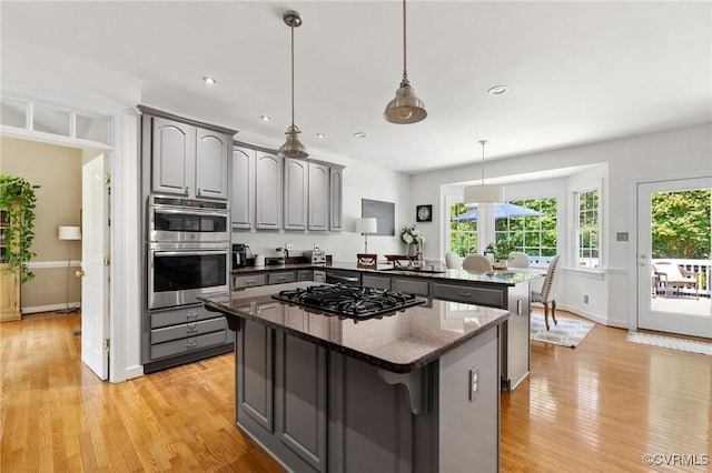 14230 Post Mill Dr, Midlothian, VA 23113 - kitchen with black gas cooktop, gray cabinets, a kitchen island, a peninsula, and light wood-type flooring