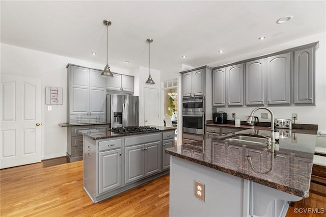 14230 Post Mill Dr, Midlothian, VA 23113 - kitchen with appliances with stainless steel finishes, gray cabinetry, a kitchen island, dark stone counters, and recessed lighting