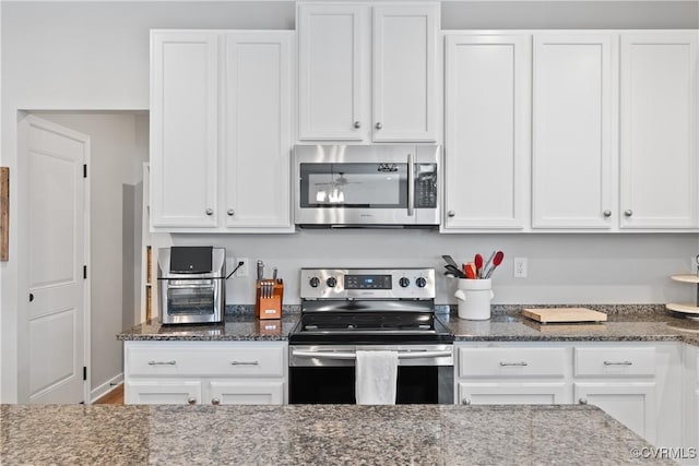 3636 Knighton Cir, Midlothian, VA 23112 - kitchen with stainless steel appliances, white cabinets, and dark stone counters