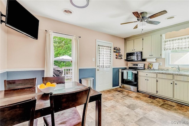 10613 Poachers Run, Chesterfield, VA 23832 - kitchen featuring stainless steel electric stove, black microwave, light countertops, and cream cabinetry
