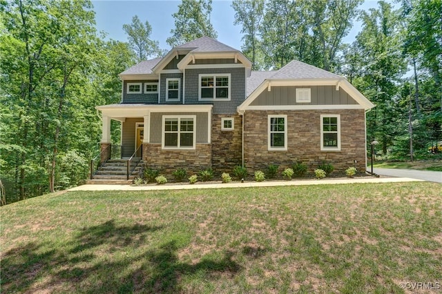 3016 Maple Grove Ln, Powhatan, VA 23139 - craftsman-style house featuring stone siding, a front lawn, covered porch, and board and batten siding