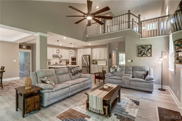 3016 Maple Grove Ln, Powhatan, VA 23139 - living room with a towering ceiling, ceiling fan, and light wood finished floors