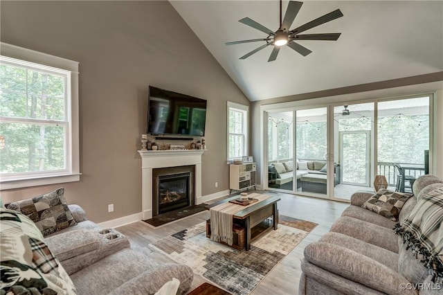 3016 Maple Grove Ln, Powhatan, VA 23139 - living room with a ceiling fan, plenty of natural light, high vaulted ceiling, and a glass covered fireplace