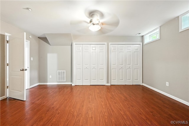 3036 Perdue Springs Ln, Chester, VA 23831 - unfurnished bedroom with wood finished floors, two closets, and ceiling fan