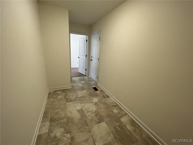 4917 Bailey Woods Ln, Midlothian, VA 23112 - hall featuring baseboards and dark stone finish flooring