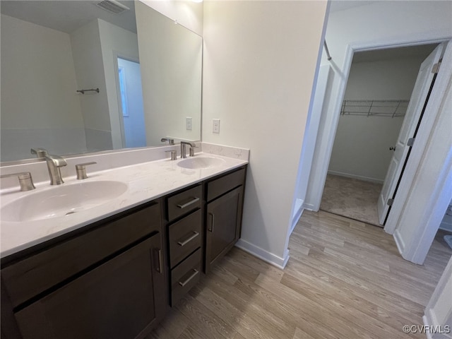 4917 Bailey Woods Ln, Midlothian, VA 23112 - full bath featuring wood finished floors, double vanity, and a walk in closet
