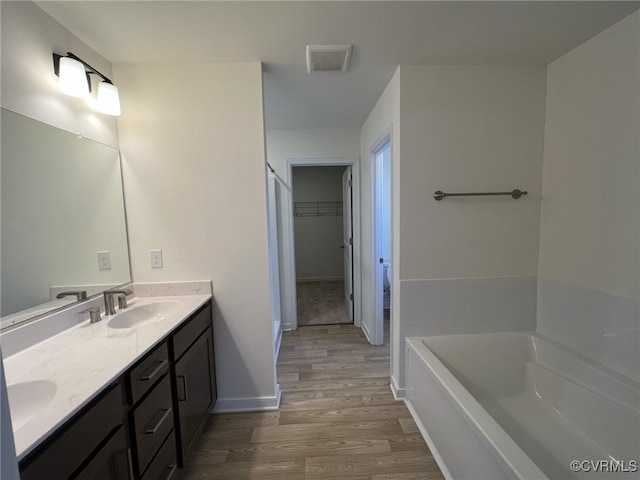 4917 Bailey Woods Ln, Midlothian, VA 23112 - full bath featuring wood finished floors, double vanity, a bath, and a spacious closet
