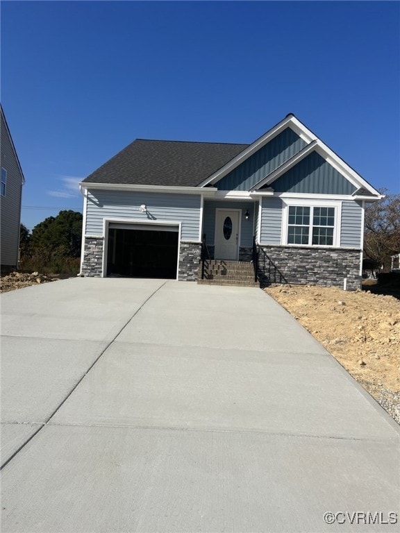 4917 Bailey Woods Ln, Midlothian, VA 23112 - view of front of home featuring stone siding, an attached garage, board and batten siding, and concrete driveway