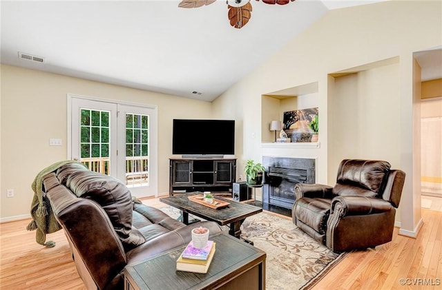 5773 S Jessup Rd, Chesterfield, VA 23832 - living room featuring light wood-type flooring, a fireplace with flush hearth, vaulted ceiling, and ceiling fan