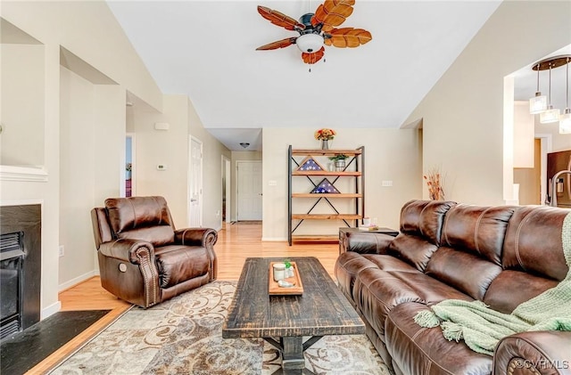 5773 S Jessup Rd, Chesterfield, VA 23832 - living area with lofted ceiling, light wood finished floors, a ceiling fan, and a fireplace with flush hearth