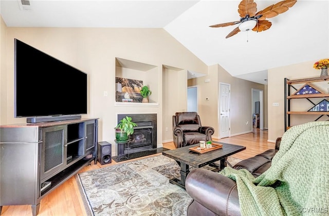 5773 S Jessup Rd, Chesterfield, VA 23832 - living area featuring a fireplace with flush hearth, light wood-style floors, ceiling fan, and vaulted ceiling