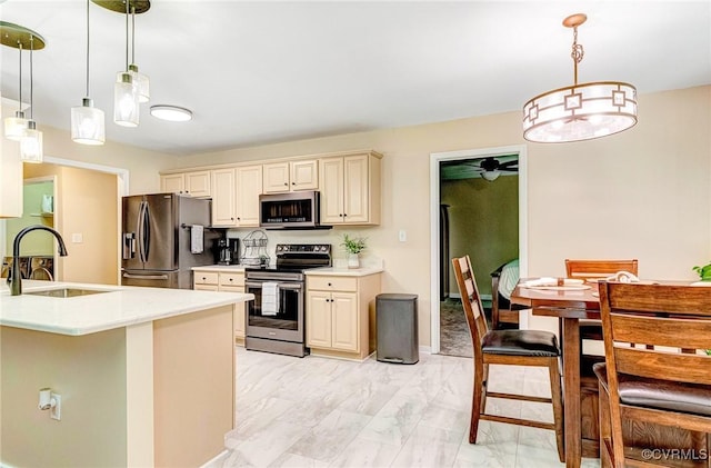 5773 S Jessup Rd, Chesterfield, VA 23832 - kitchen featuring appliances with stainless steel finishes, cream cabinetry, light countertops, a ceiling fan, and light marble finish floors