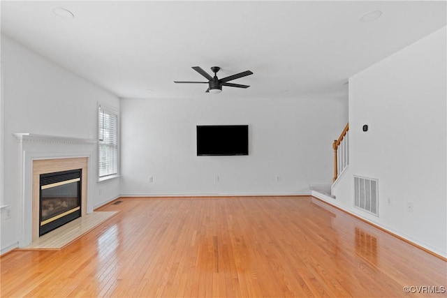 5413 Cranston Ct, Henrico, VA 23059 - unfurnished living room with a fireplace, stairway, a ceiling fan, and light wood finished floors
