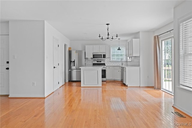 5413 Cranston Ct, Henrico, VA 23059 - kitchen with stainless steel appliances, a chandelier, light wood-style floors, and plenty of natural light