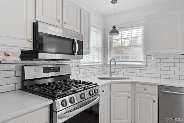 5413 Cranston Ct, Henrico, VA 23059 - kitchen with stainless steel appliances, white cabinetry, backsplash, and light countertops