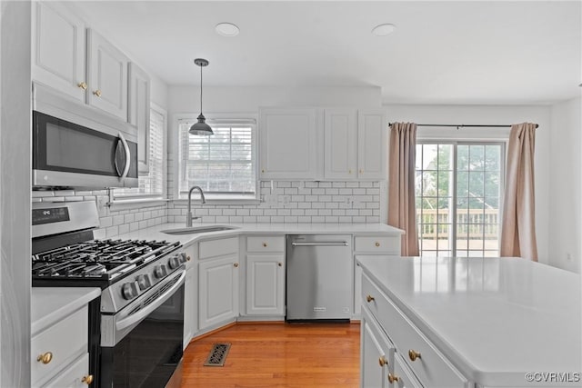 5413 Cranston Ct, Henrico, VA 23059 - kitchen with stainless steel appliances, backsplash, light countertops, white cabinetry, and recessed lighting
