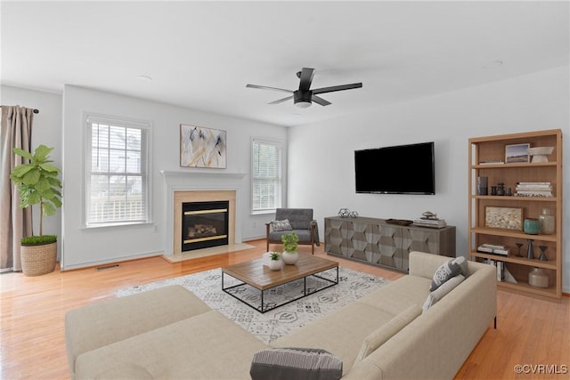 5413 Cranston Ct, Henrico, VA 23059 - living room with healthy amount of natural light, ceiling fan, wood finished floors, and a fireplace with flush hearth