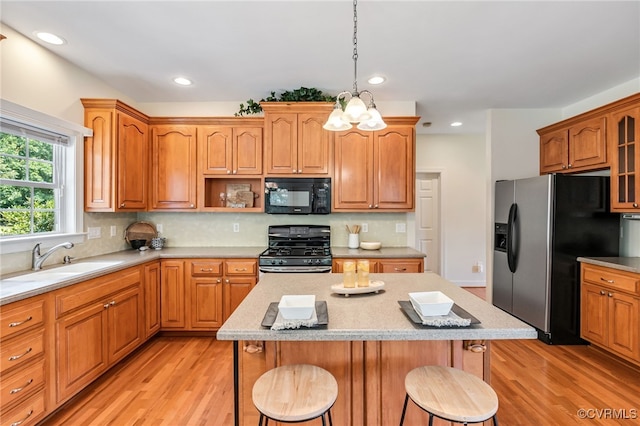 6125 Trinity Church Rd, Dinwiddie, VA 23833 - kitchen with appliances with stainless steel finishes, a kitchen bar, light wood-style floors, a center island, and recessed lighting