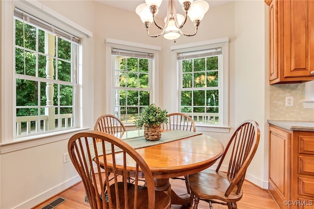 6125 Trinity Church Rd, Dinwiddie, VA 23833 - dining space featuring light wood-style floors, a chandelier, and plenty of natural light