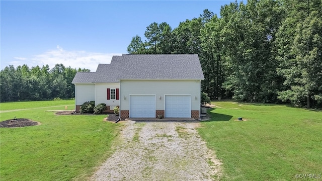 6125 Trinity Church Rd, Dinwiddie, VA 23833 - view of front facade featuring driveway, a garage, a front yard, and roof with shingles