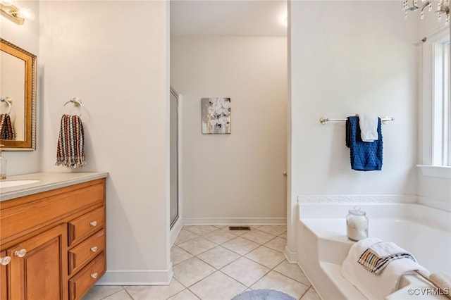 6125 Trinity Church Rd, Dinwiddie, VA 23833 - full bathroom featuring vanity, a garden tub, tile patterned floors, and a stall shower