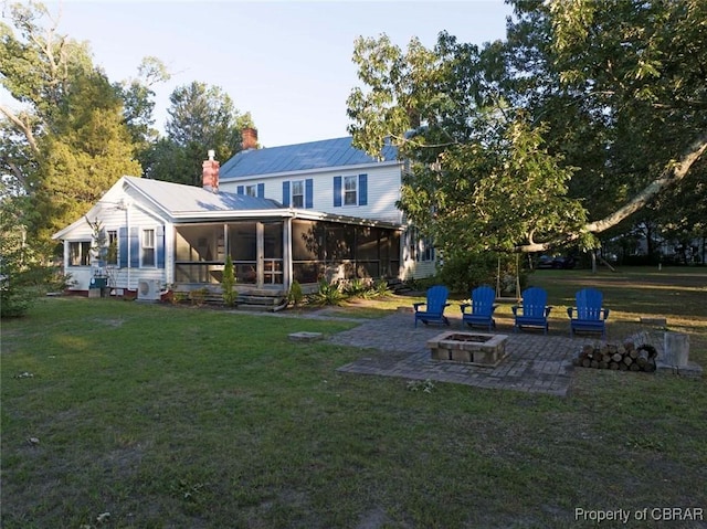 186 Bay Shore Point Rd, Port Haywood, VA 23138 - rear view of property with an outdoor fire pit, a patio, a sunroom, and a lawn