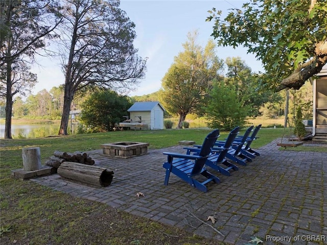 186 Bay Shore Point Rd, Port Haywood, VA 23138 - view of patio with a fire pit, a shed, and a water view