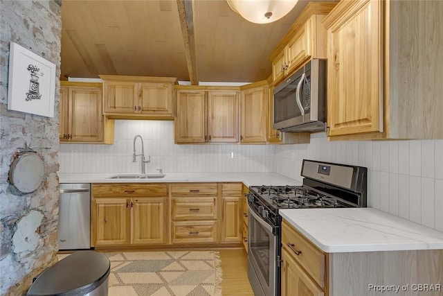 186 Bay Shore Point Rd, Port Haywood, VA 23138 - kitchen with stainless steel appliances, light brown cabinetry, tasteful backsplash, and lofted ceiling