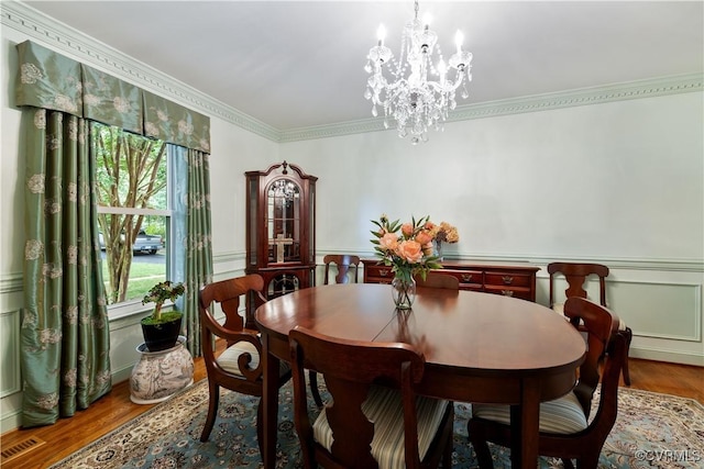 4310 Courthouse Rd, Prince George, VA 23875 - dining space featuring wood finished floors, crown molding, a chandelier, a wainscoted wall, and a decorative wall