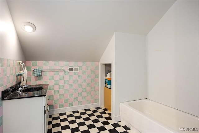 4310 Courthouse Rd, Prince George, VA 23875 - full bathroom featuring tile patterned floors, vanity, a tub, and vaulted ceiling