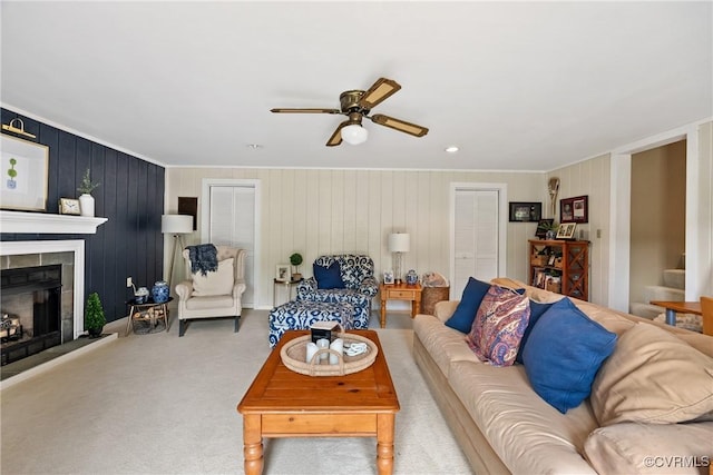 275 Meadowview Ln, Farmville, VA 23901 - carpeted living room featuring ceiling fan, ornamental molding, a large fireplace, stairway, and wood walls