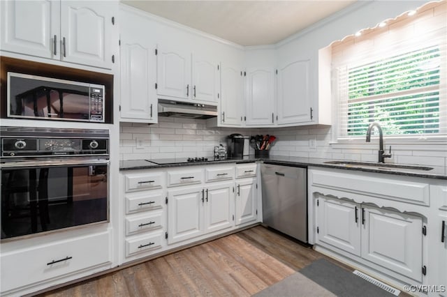 12001 Buckhorn Rd, Chesterfield, VA 23838 - kitchen with oven, stainless steel dishwasher, ornamental molding, white cabinetry, and tasteful backsplash