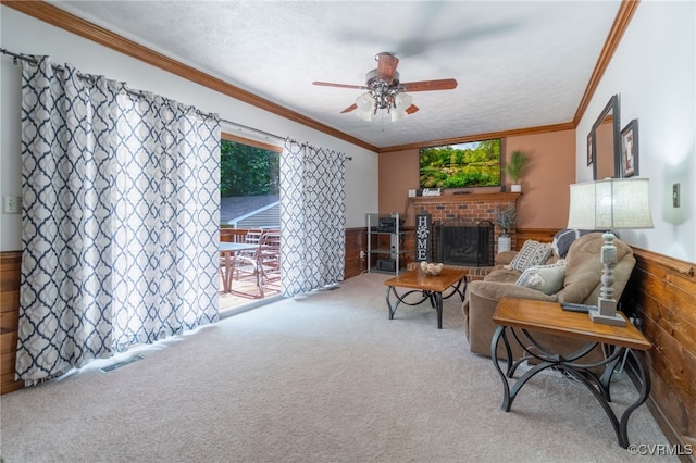12001 Buckhorn Rd, Chesterfield, VA 23838 - carpeted living room featuring ceiling fan, a fireplace, a wainscoted wall, ornamental molding, and wooden walls