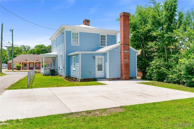 521 S Sycamore St, Petersburg, VA 23803 - view of front of home with a chimney, a front yard, and a porch