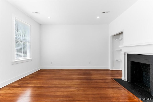 521 S Sycamore St, Petersburg, VA 23803 - unfurnished living room with a fireplace with flush hearth, wood finished floors, and recessed lighting