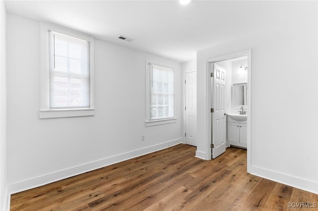 521 S Sycamore St, Petersburg, VA 23803 - unfurnished bedroom featuring wood finished floors and connected bathroom