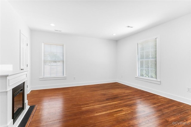 521 S Sycamore St, Petersburg, VA 23803 - unfurnished living room featuring a glass covered fireplace, plenty of natural light, wood-type flooring, and recessed lighting