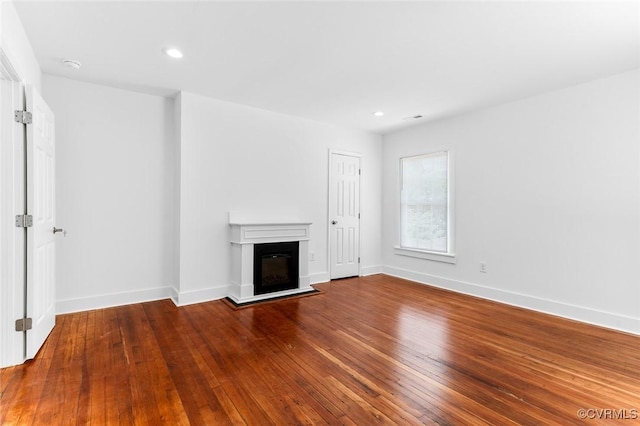 521 S Sycamore St, Petersburg, VA 23803 - unfurnished living room featuring hardwood / wood-style floors, a glass covered fireplace, and recessed lighting