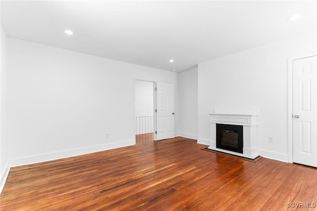 521 S Sycamore St, Petersburg, VA 23803 - unfurnished living room featuring hardwood / wood-style flooring, a glass covered fireplace, and recessed lighting