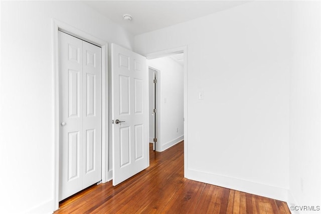 521 S Sycamore St, Petersburg, VA 23803 - unfurnished bedroom with a closet and dark wood-style floors
