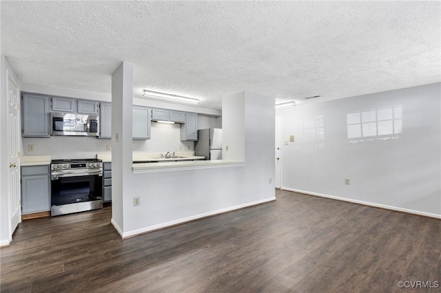 7604 Roscommon Ct Unit 2403, Henrico, VA 23228 - kitchen with stainless steel appliances, dark wood-style floors, gray cabinetry, a textured ceiling, and light countertops