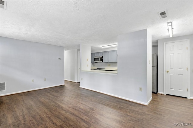 7604 Roscommon Ct Unit 2403, Henrico, VA 23228 - unfurnished living room featuring dark wood-style floors and a textured ceiling