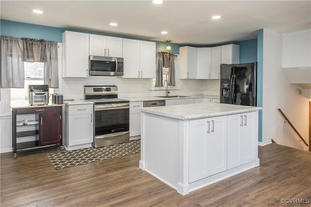 15601 Meridian Ave, Chester, VA 23831 - kitchen with stainless steel appliances, dark wood-style flooring, white cabinets, light countertops, and recessed lighting