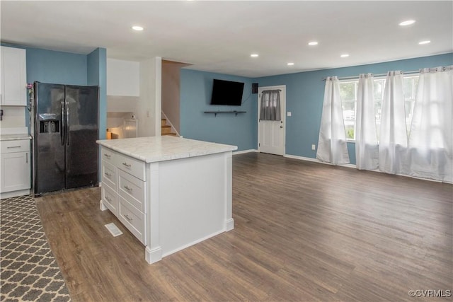 15601 Meridian Ave, Chester, VA 23831 - kitchen featuring black fridge, open floor plan, dark wood-style floors, white cabinetry, and recessed lighting