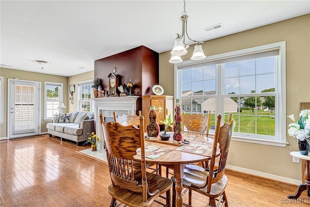 8125 Janice Ave, Mechanicsville, VA 23111 - dining space with healthy amount of natural light, light wood-type flooring, and a chandelier