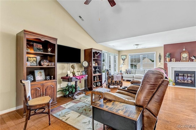 8125 Janice Ave, Mechanicsville, VA 23111 - living room featuring light wood-style flooring, ceiling fan, a premium fireplace, and high vaulted ceiling