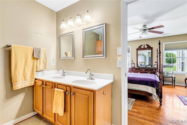 8125 Janice Ave, Mechanicsville, VA 23111 - full bathroom with double vanity, a ceiling fan, and wood finished floors