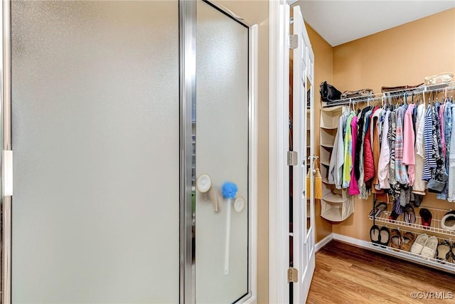 8125 Janice Ave, Mechanicsville, VA 23111 - bathroom featuring a shower stall, a walk in closet, and wood finished floors