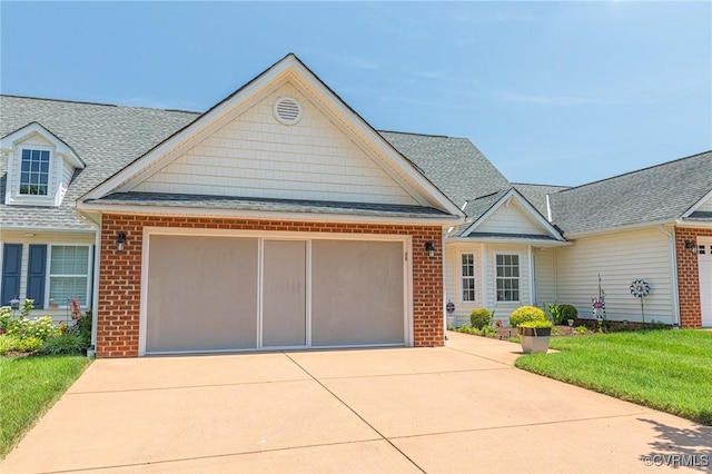 8125 Janice Ave, Mechanicsville, VA 23111 - view of front of property featuring brick siding, an attached garage, and concrete driveway
