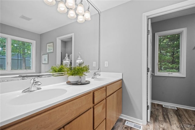 9712 Kingussle Ln, North Chesterfield, VA 23236 - bathroom with double vanity, wood finished floors, plenty of natural light, and a chandelier